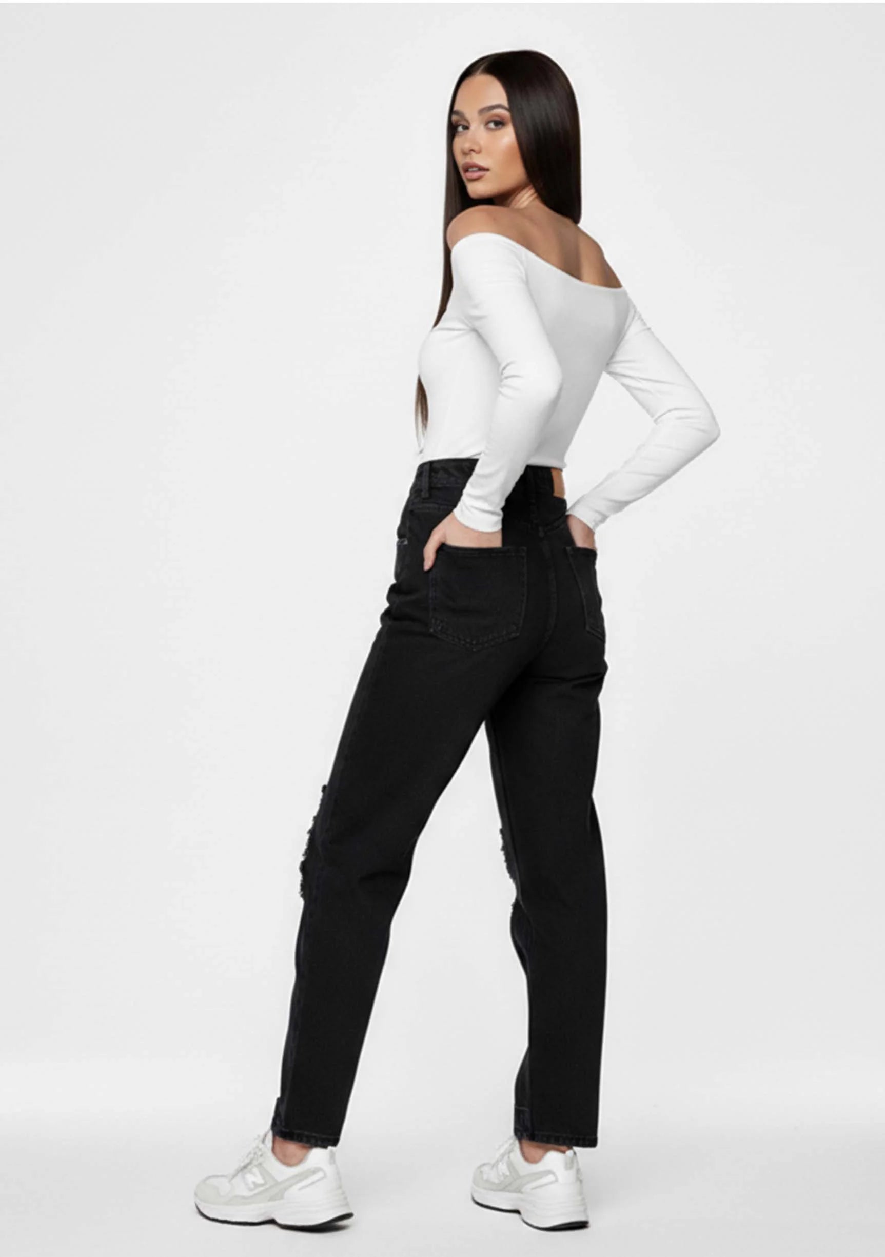 Back angled view of a model in Ladies Black Wash Straight Cut Denim