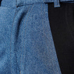 Close up of the front pocket and side seam on ladies color block straight leg jeans.