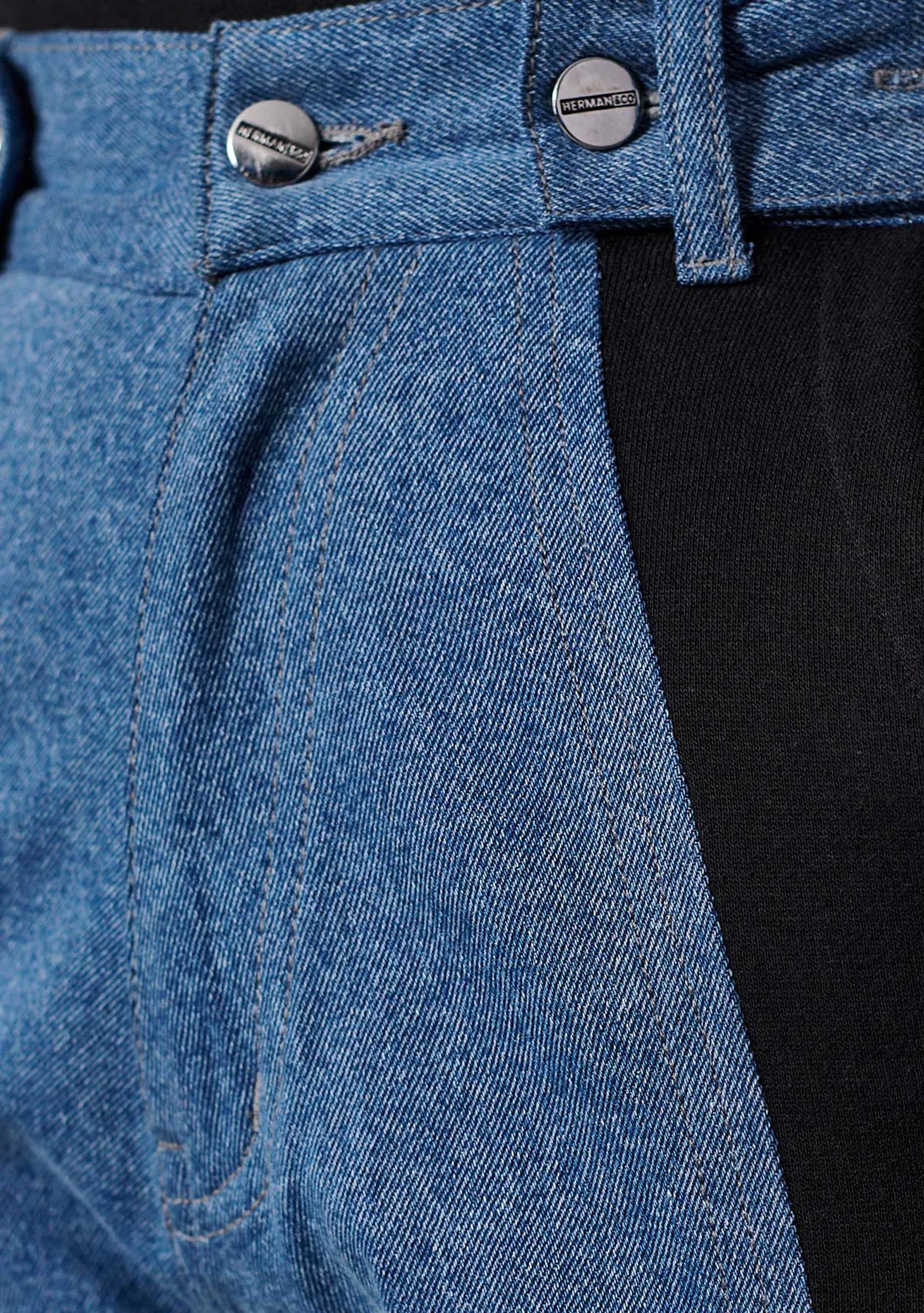 Close up of the front pocket and side seam on ladies color block straight leg jeans.
