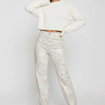 Side profile view of ladies fluid marble tapered pants showcasing the form-fitting silhouette.