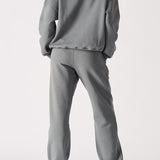 Back view of a model in the comfortable ladies oversized grey sweatshirt.