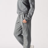 Side profile of a model posing in the relaxed ladies oversized grey sweatshirt.