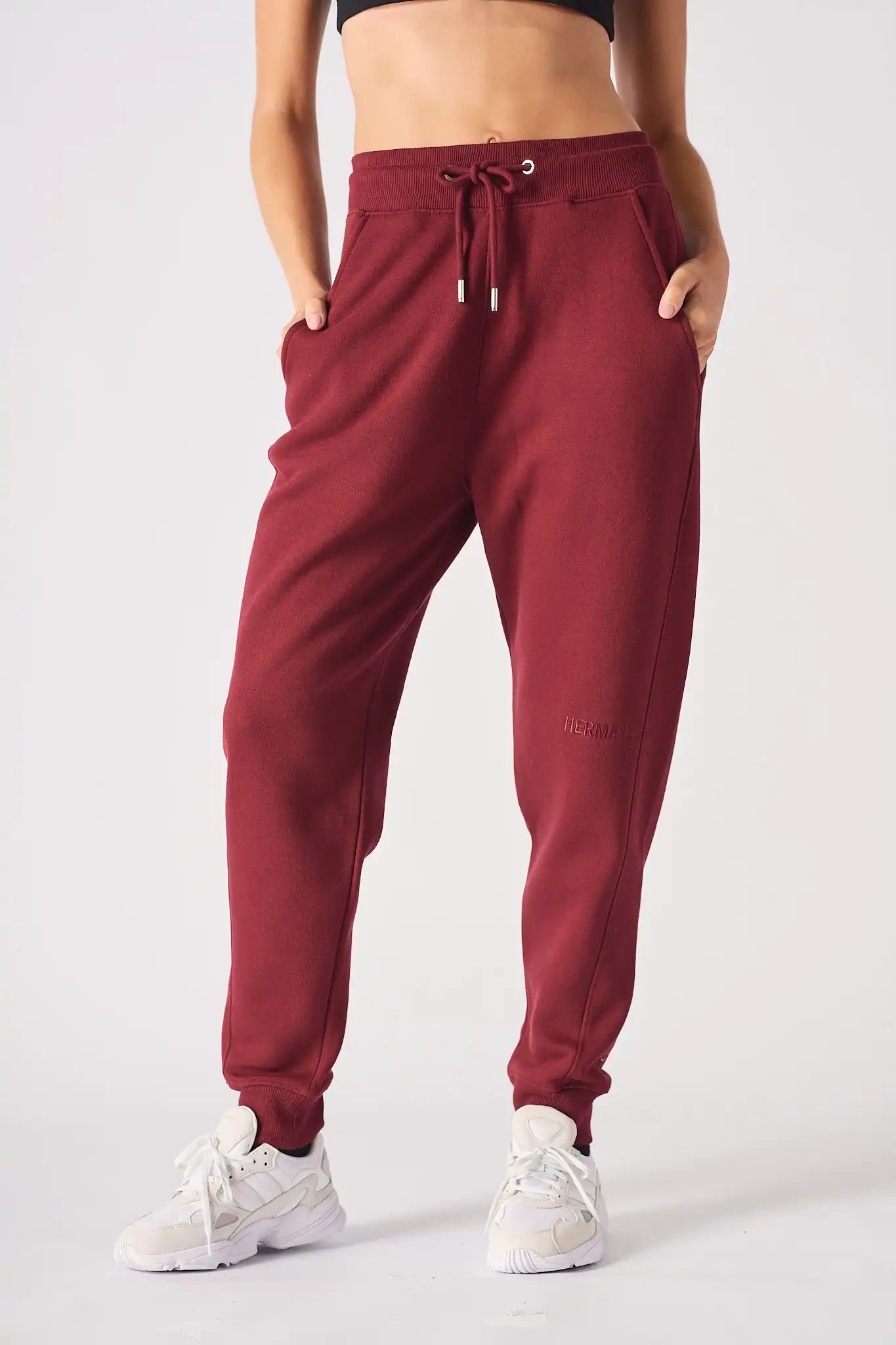 Full front shot of a model wearing high rise ladies red joggers.