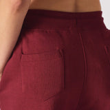 Detailed shot of the back pocket area on the burgundy ladies red joggers.