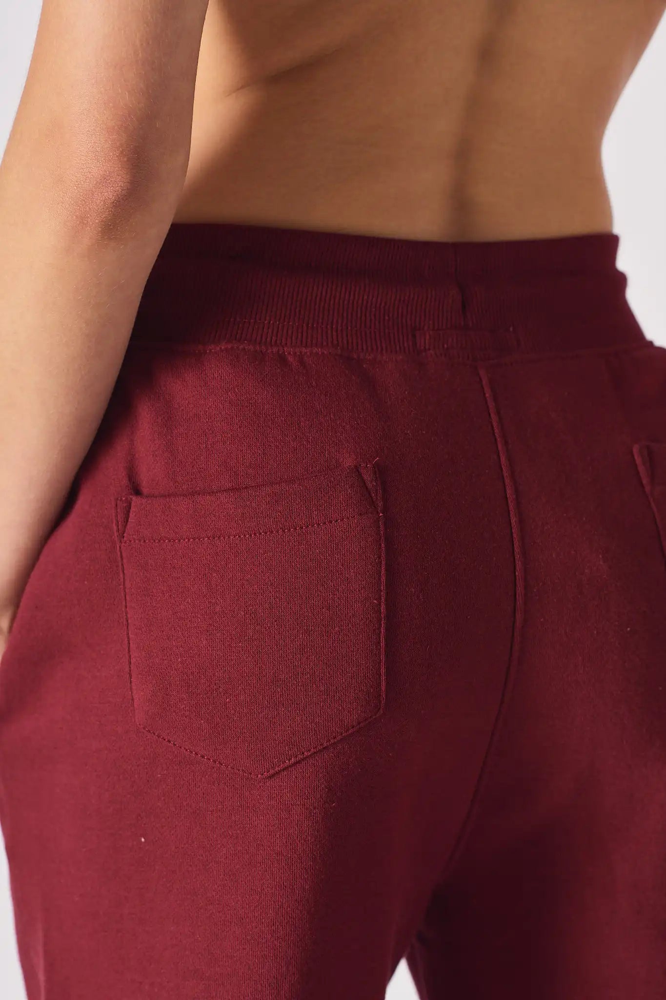 Detailed shot of the back pocket area on the burgundy ladies red joggers.