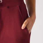 Close up view of the functional side pocket on these premium ladies red joggers.