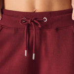 Close up of the adjustable drawstring waistband on the ladies red joggers.
