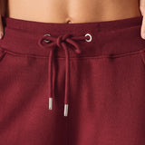 Close up of the adjustable drawstring waistband on the ladies red joggers.