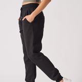 Side profile of the ladies' black tapered joggers to show the tapered leg