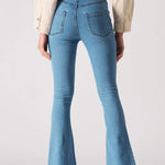 Full back view of women's light blue bootcut jeans showing back patch pockets
