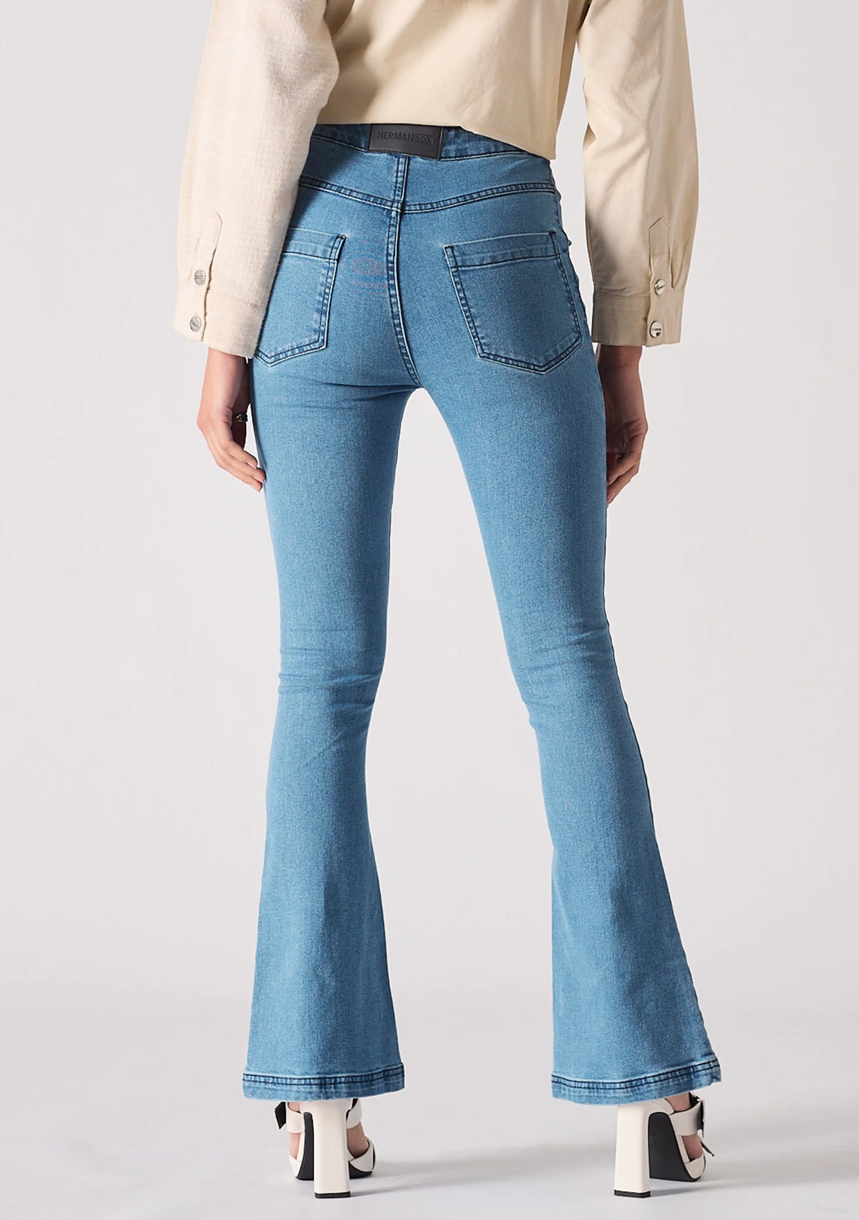Full back view of women's light blue bootcut jeans showing back patch pockets