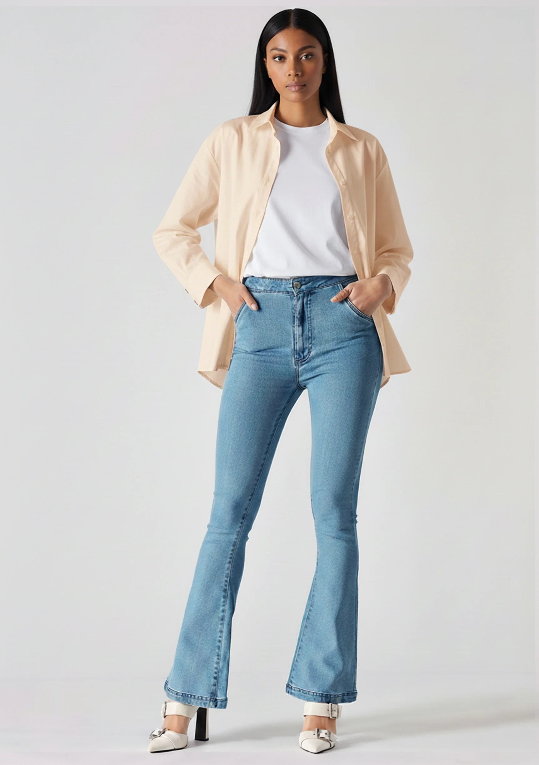 Front view of women's high-waisted light blue bootcut jeans with slip pockets