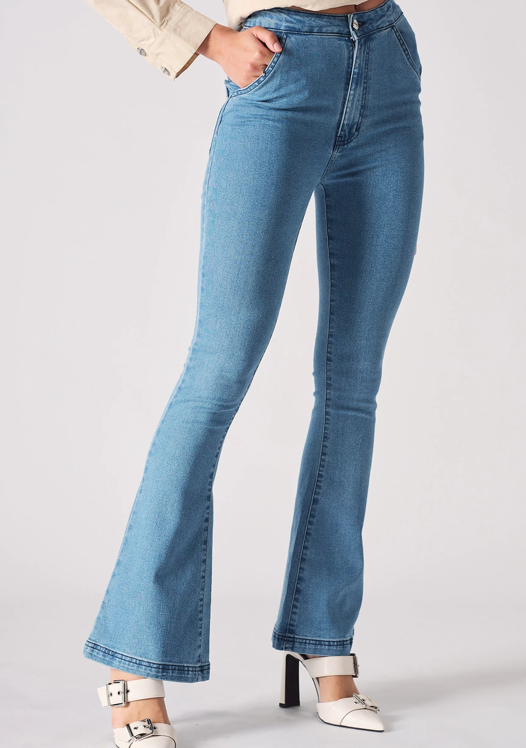 Side profile view of model wearing high-waisted light blue bootcut denim