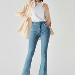 Studio shot of model standing straight in women's light blue bootcut denim jeans