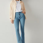 Full front view of a model in trendy light blue bootcut jeans