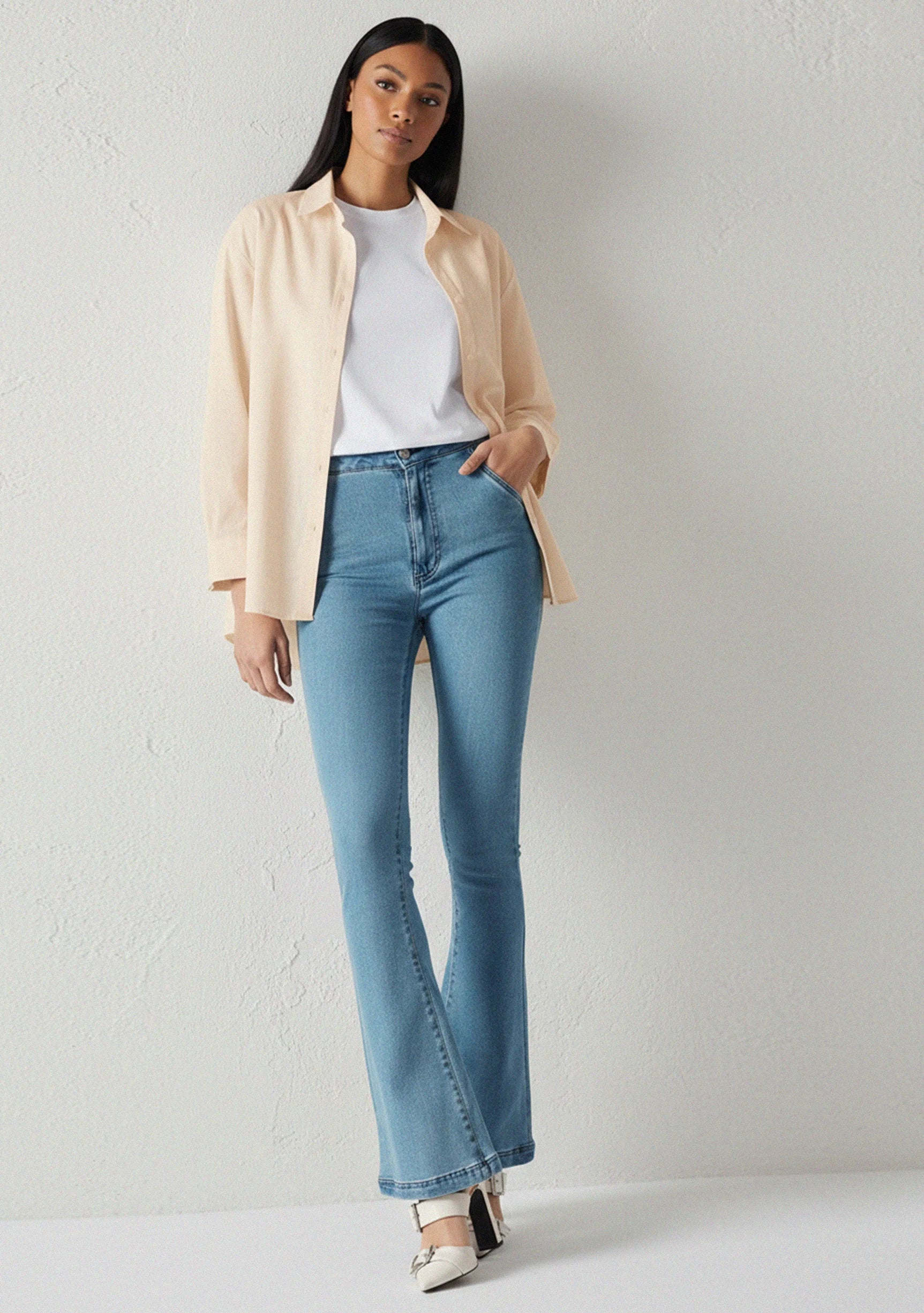 Full front view of a model in trendy light blue bootcut jeans