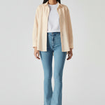 Front walking pose showing the fit and drape of light blue high-waisted jeans