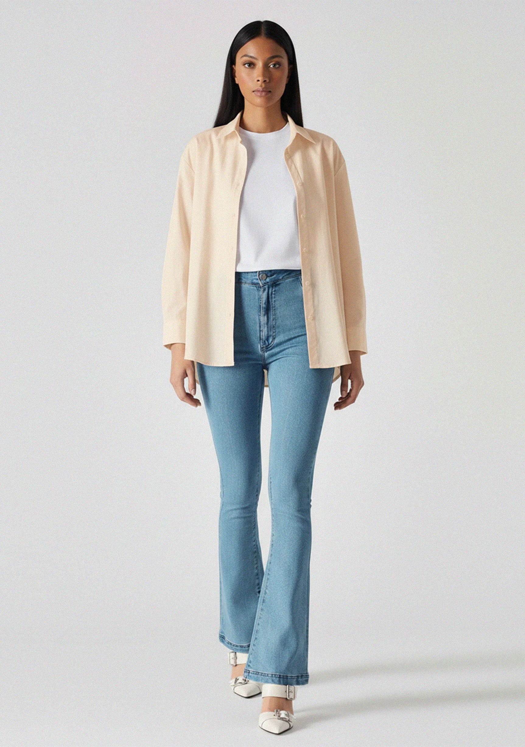 Front walking pose showing the fit and drape of light blue high-waisted jeans