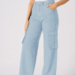 A full length shot of a model wearing light blue cargo jeans for women and white trainers.