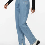 Person wearing light blue jeans and white platform boots on a white background