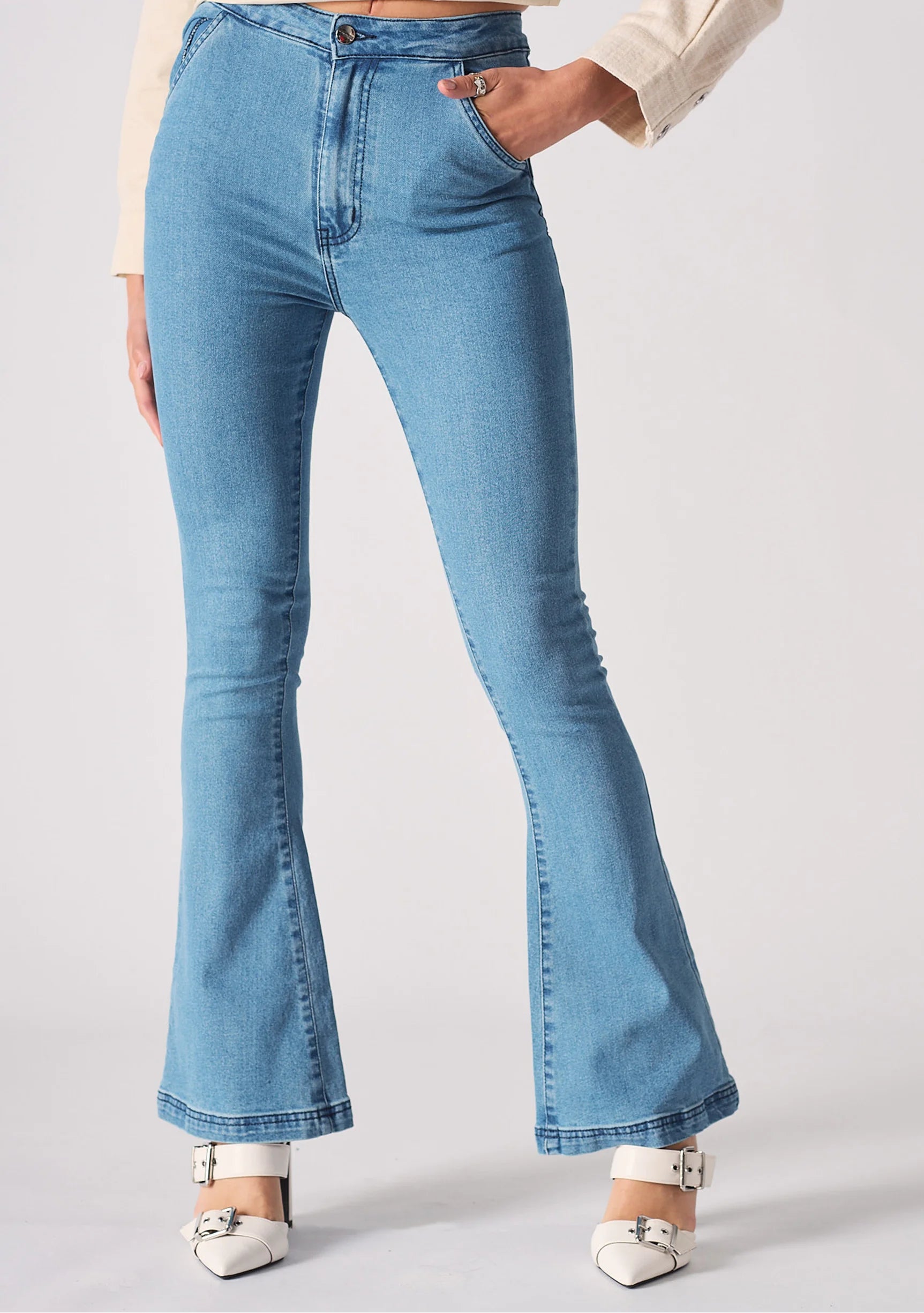 Close up texture view of the front slip pocket on light blue denim jeans