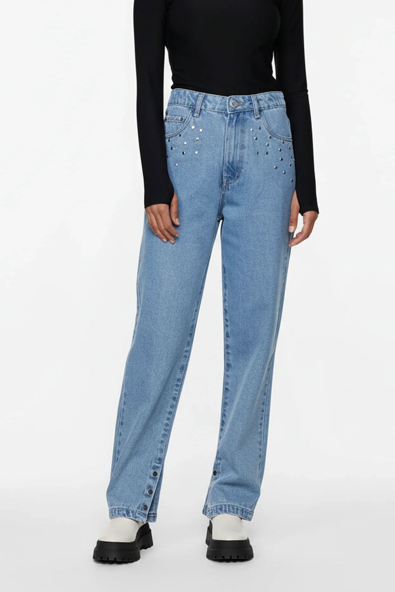 Light blue jeans worn by a person on a white background
