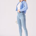 Side profile of a woman wearing light blue jeggings for women highlighting the slim and streamlined silhouette.