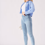 Side profile of a woman wearing light blue jeggings for women highlighting the slim and streamlined silhouette.