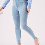 A model in a walking pose to demonstrate the flexibility and movement of the light blue jeggings.