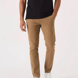 Front view of man walking in light brown pants for men