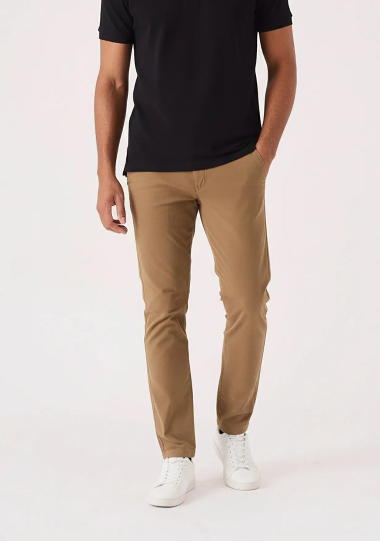 Front view of man walking in light brown pants for men