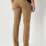 Back pocket and fit details of mens light brown pants