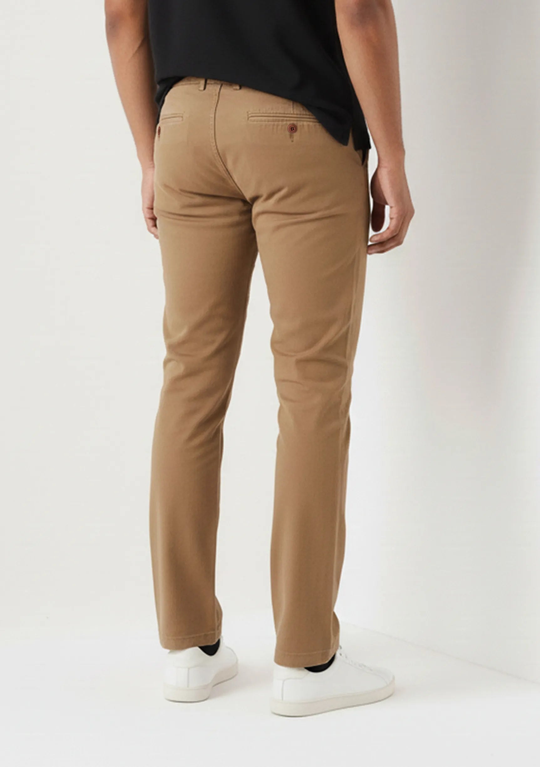 Back pocket and fit details of mens light brown pants