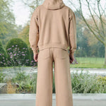 Back view of a model in the men's beige wide-leg joggers