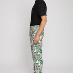 Side profile of a model showing the fit of the men's printed jeans.