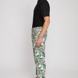 Side profile of a model showing the fit of the men's printed jeans.