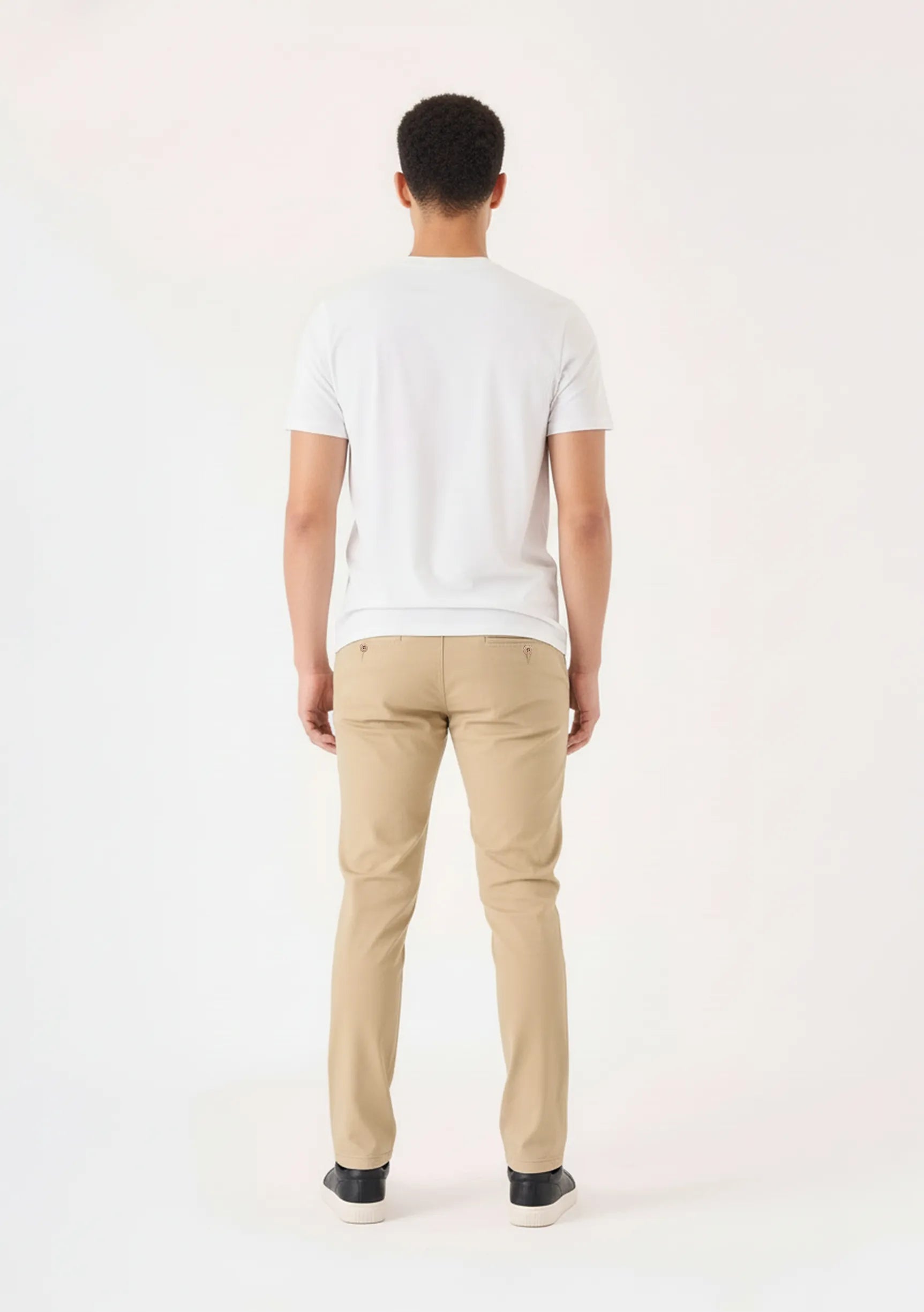 Full back view of a man standing straight in tailored mens beige trousers.