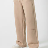 Angled front view showing the relaxed silhouette of the Herman men's beige joggers.