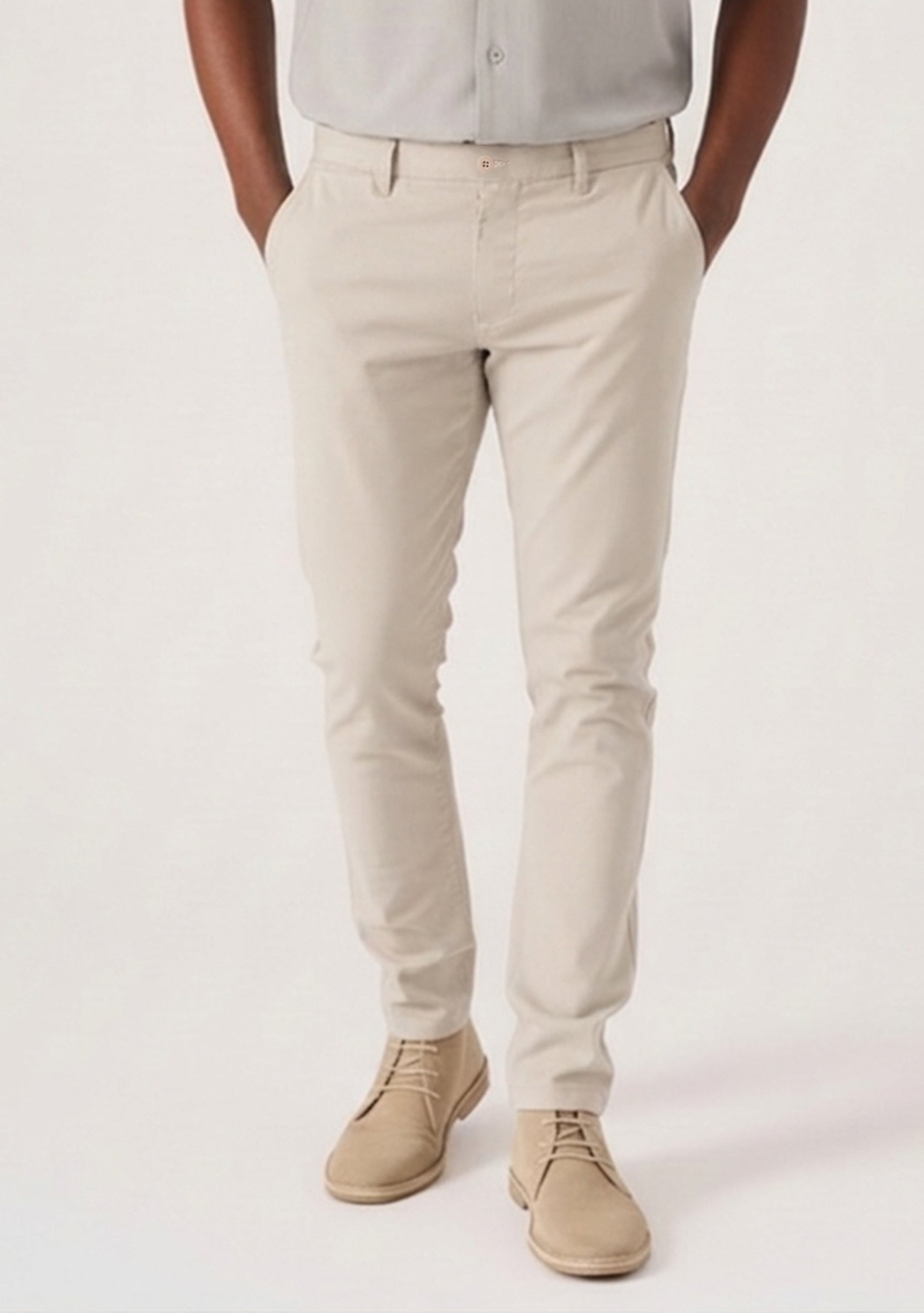 Confident model with arms crossed wearing a premium stretch cream chino.