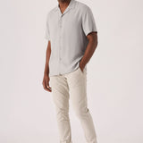 Handsome man styling comfortable mens cream chinos in a stretch slim fit design.