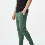 side view showing side pocket on dark green tapered joggers