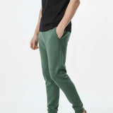 side view showing side pocket on dark green tapered joggers