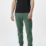 man standing straight in dark green tapered joggers
