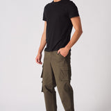 Front angled shot of a model in green cotton cargo pants featuring a modern utility design.