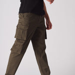 Detailed shot of the adjustable waistband and button closure on the green cargo chinos.