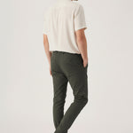 Back angled view of a model wearing comfortable mens olive green chinos by Jmojo.
