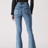 Back view of women's mid blue bootcut jeans showing classic back patch pockets