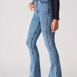 Angled side view of model wearing high-waisted mid blue bootcut jeans