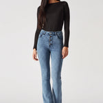 Angled front view showing the fit of mid blue exposed button fly jeans