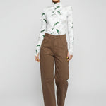 Front walking pose showing the wide leg silhouette of brown utility pants